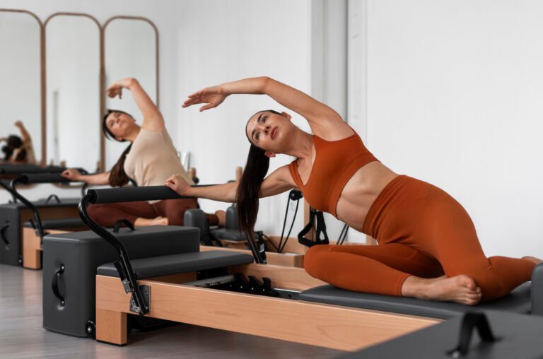 people-taking-pilates-reformer-class
